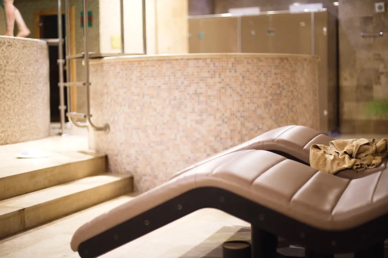Spa relaxation area with lounge chairs and pool
